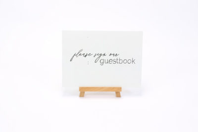 White wooden sign- "Please sign our guest book"