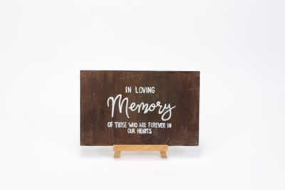 Dark wooden sign- "In loving memory"